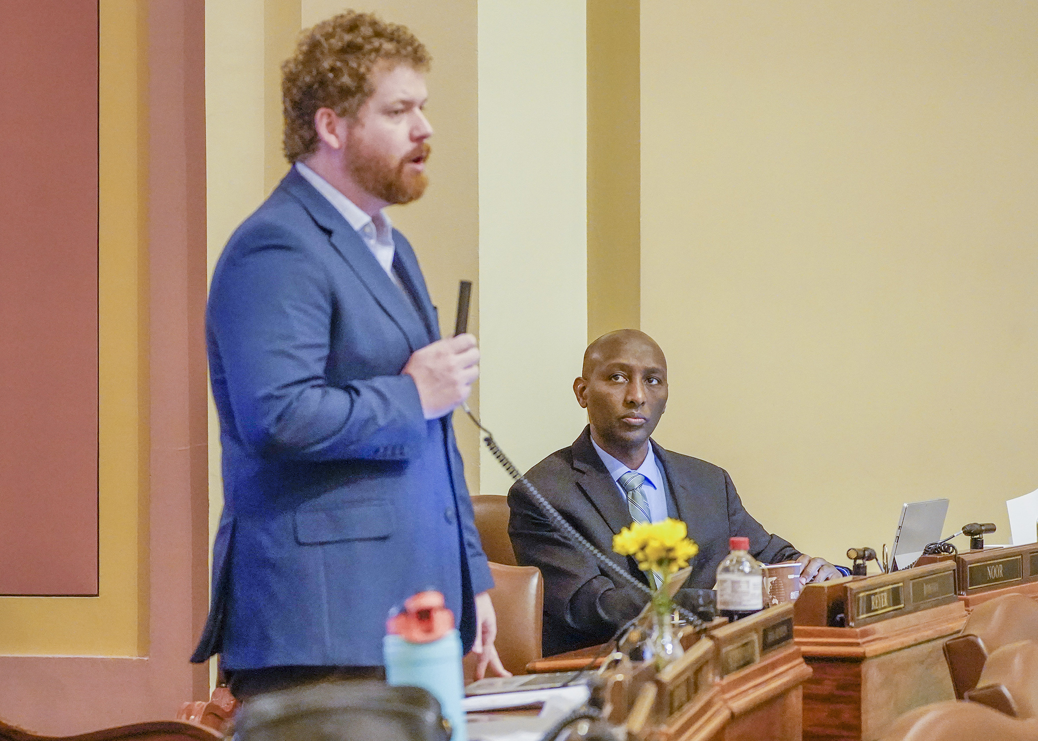 Rep. Mohamud Noor listens May 4 as Rep. Zack Stephenson explains the commerce portion of the omnibus workforce, business development, climate and energy supplemental finance and policy bill. (Photo by Andrew VonBank)